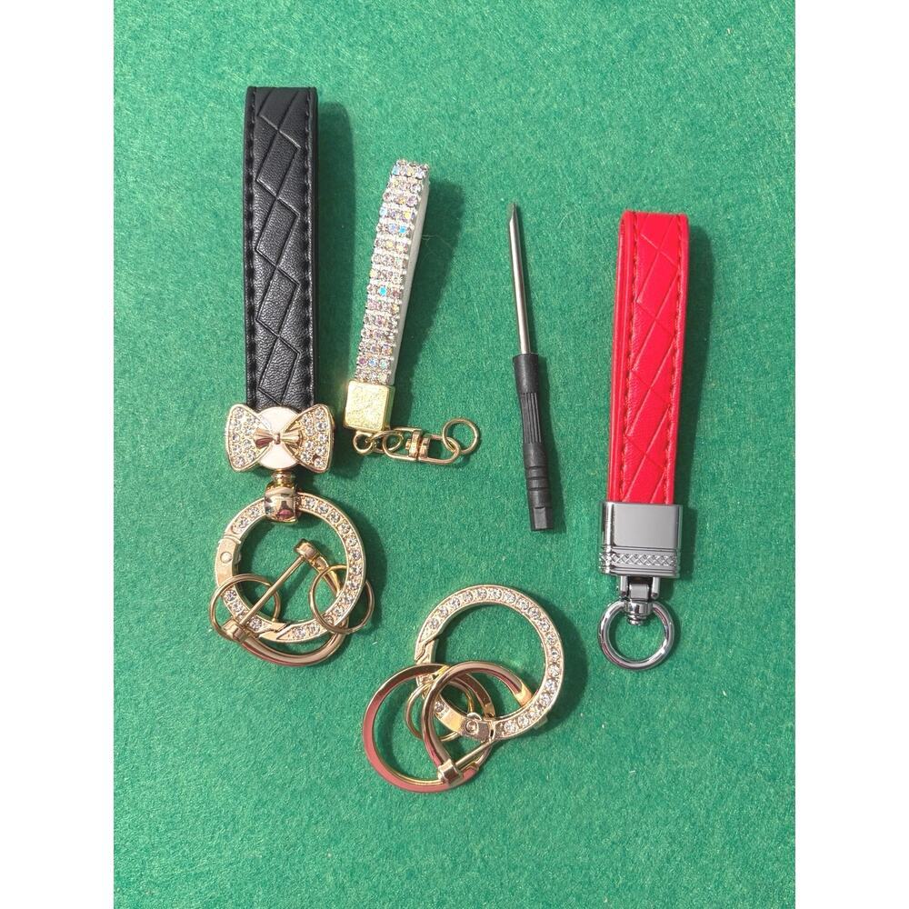 Collection of key fob embellishments, leather straps, bling, rings, bow